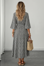 Editorial back view of black and white geometric wave maxi dress