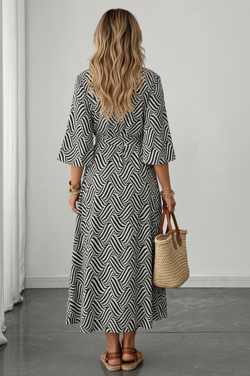 Editorial back view of black and white geometric wave maxi dress