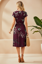 Editorial back view of burgundy floral wrap dress